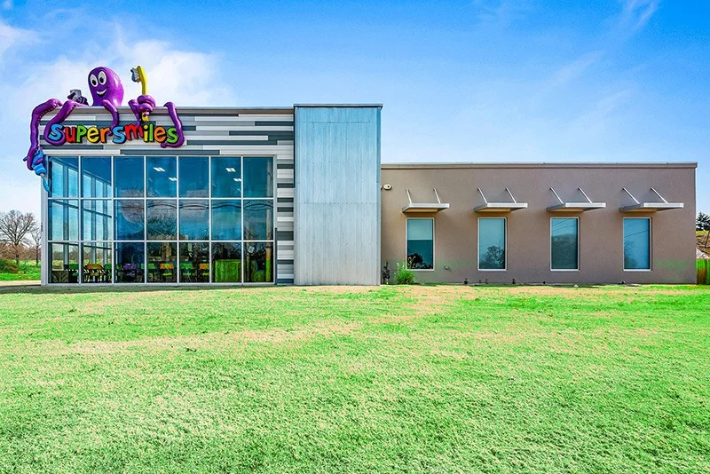 Super Smiles building exterior with the giant purple octopus logo, Harrison AR